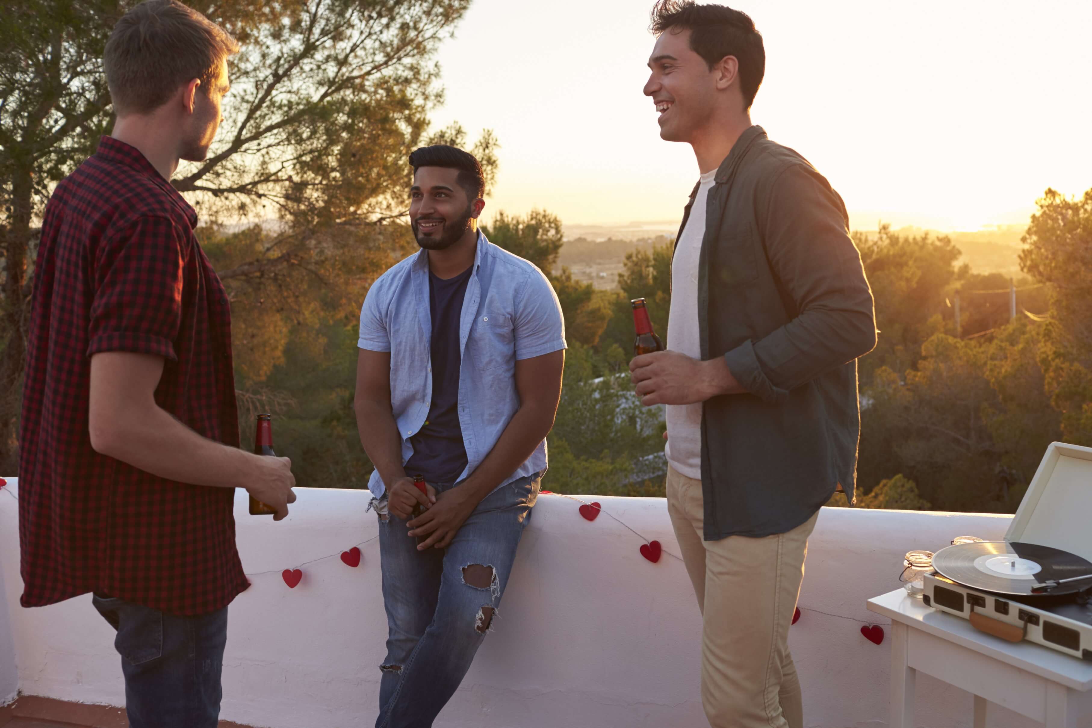 Three men talking in a garden