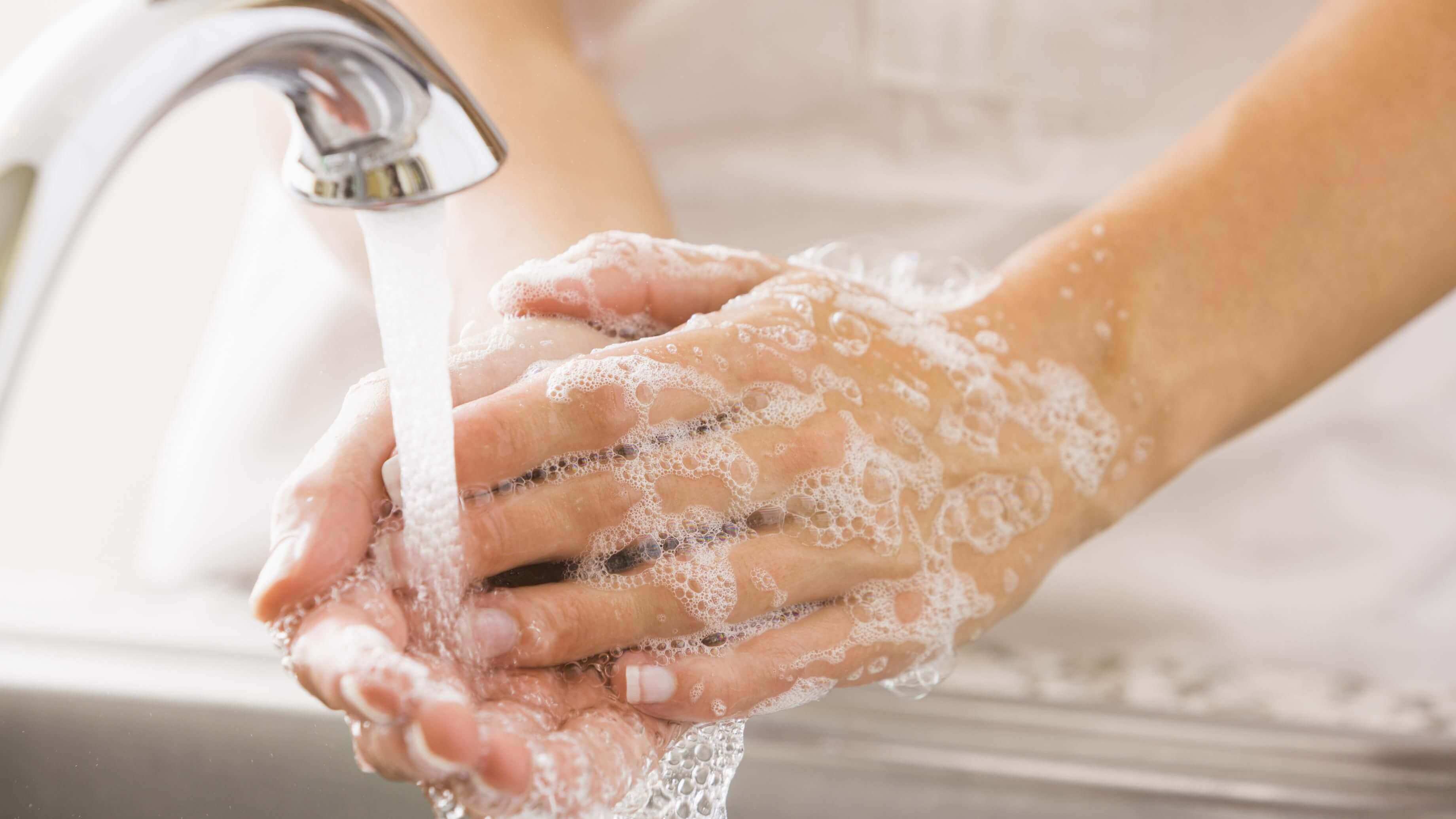 Person washing their hands in a sink