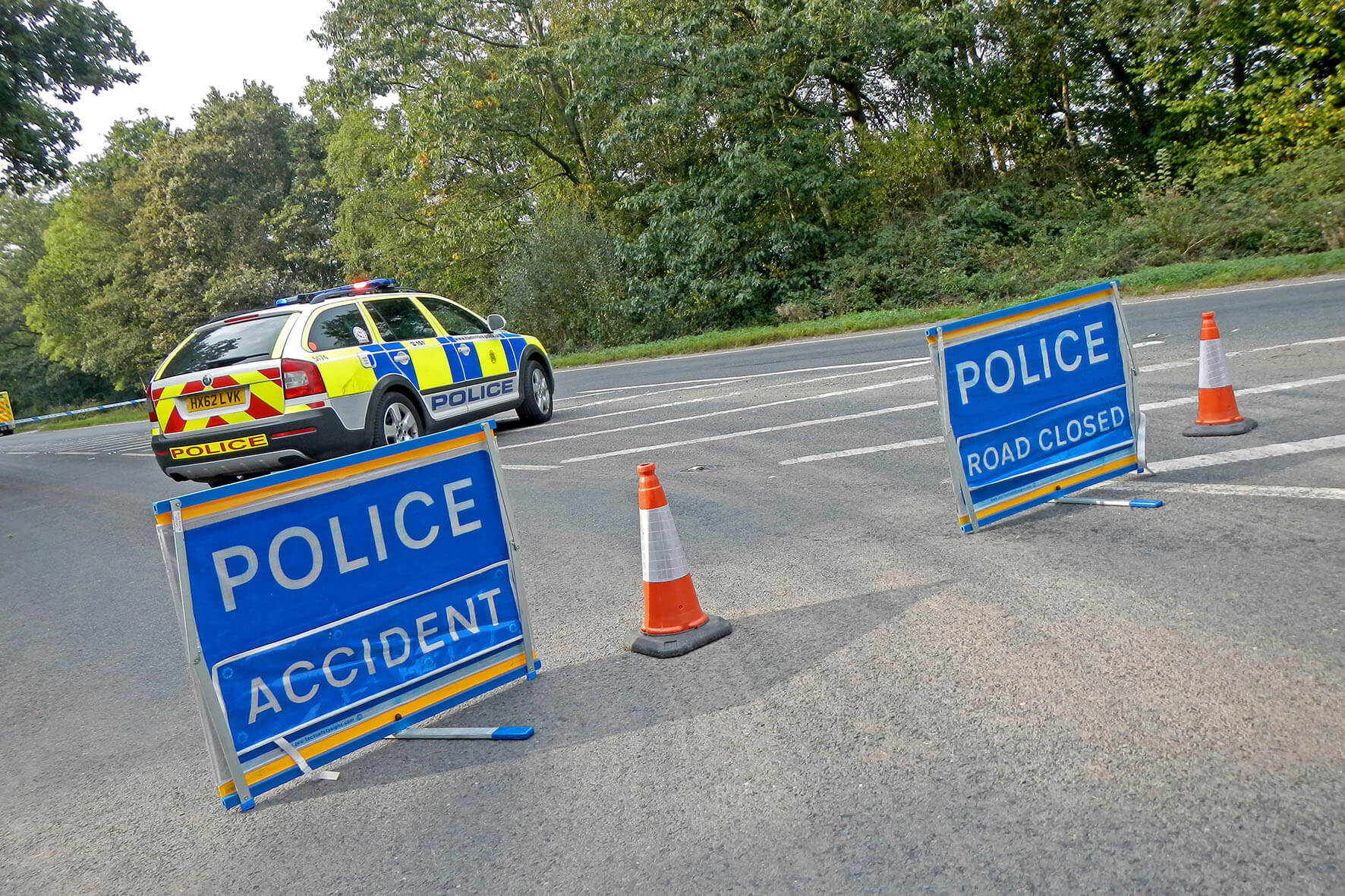 Police car and traffic cones blocking a road