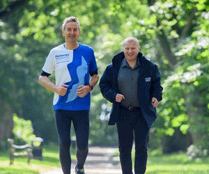 Greg Lowson running through a park