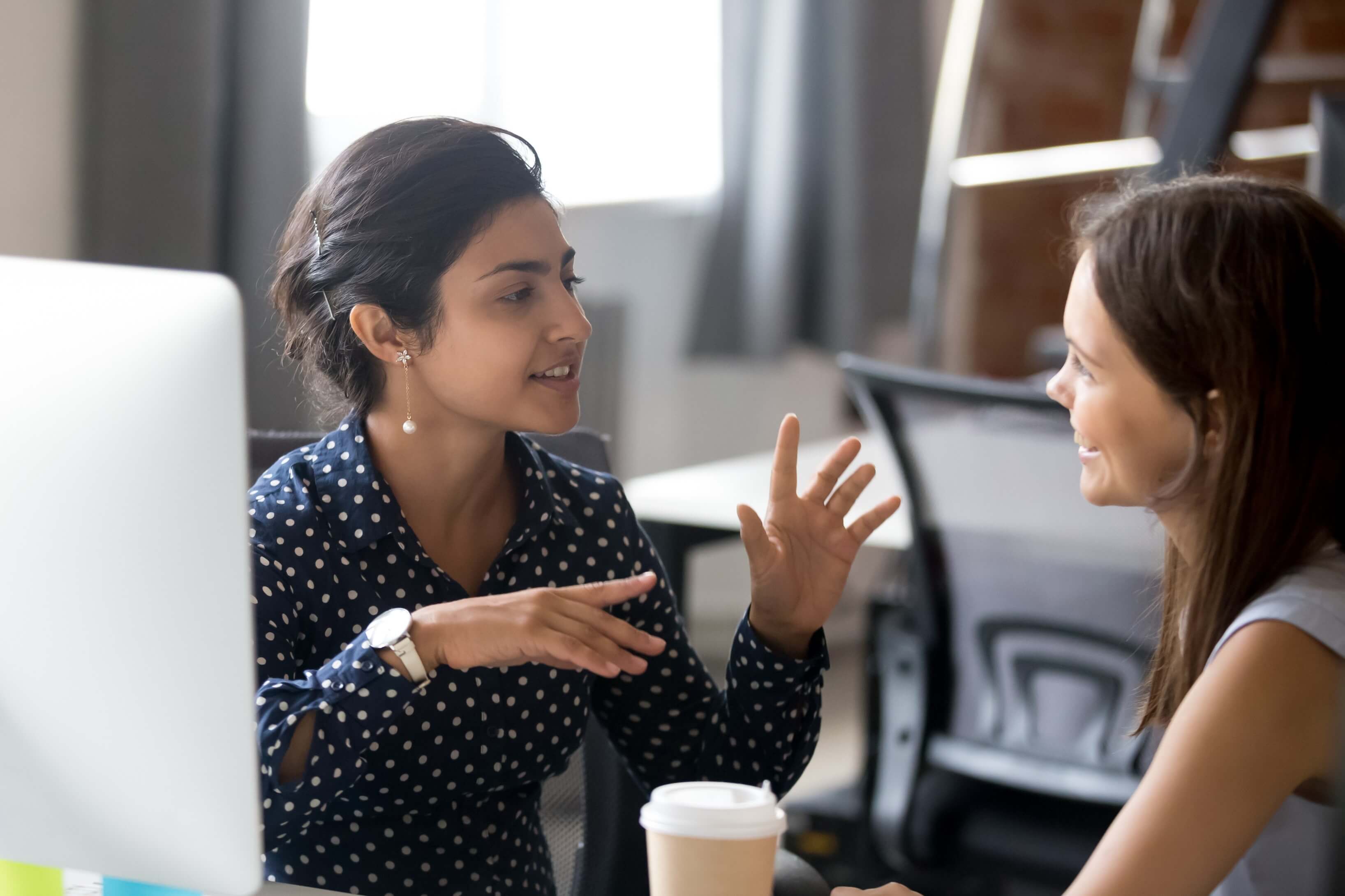 Two women talking in an office