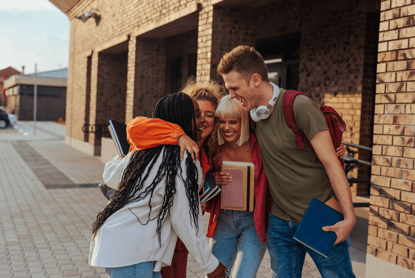 group of students outside a school building celebrating