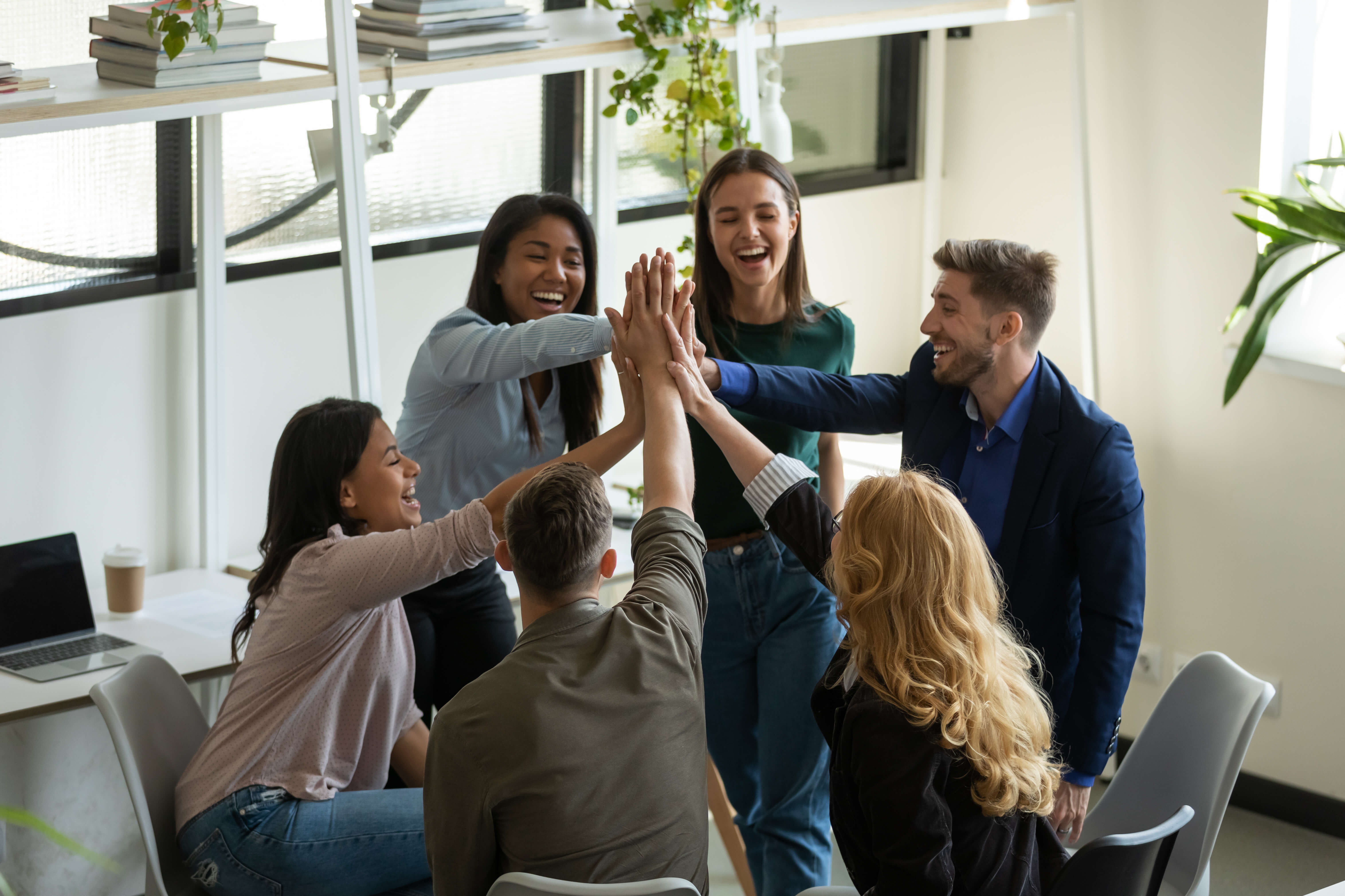 team of office workers high fiving