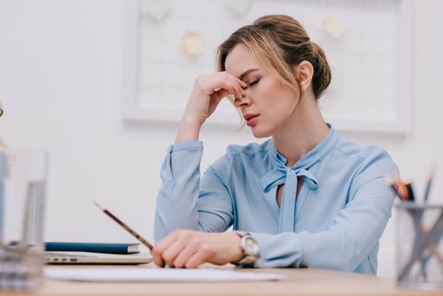 women looks disheartened with head in her hands